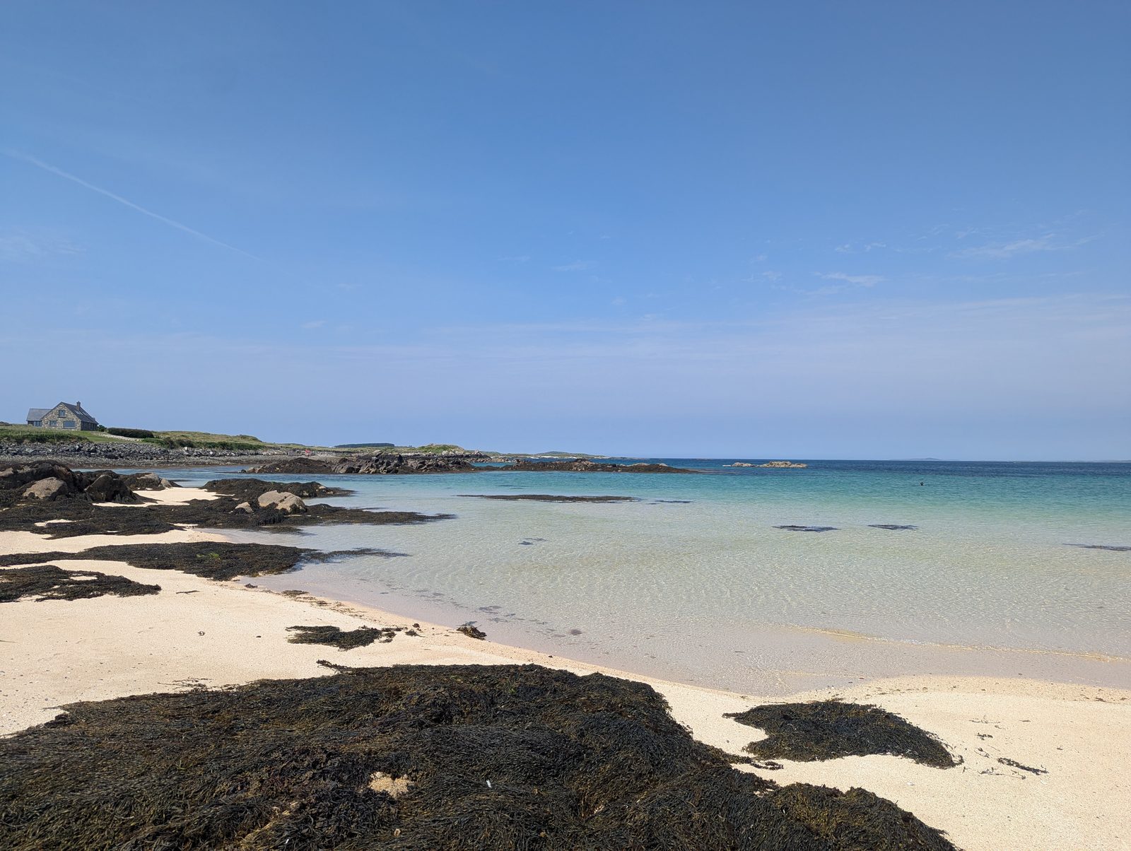 Mannin Bay's pale sand and turquoise water on a clear day in Connemara