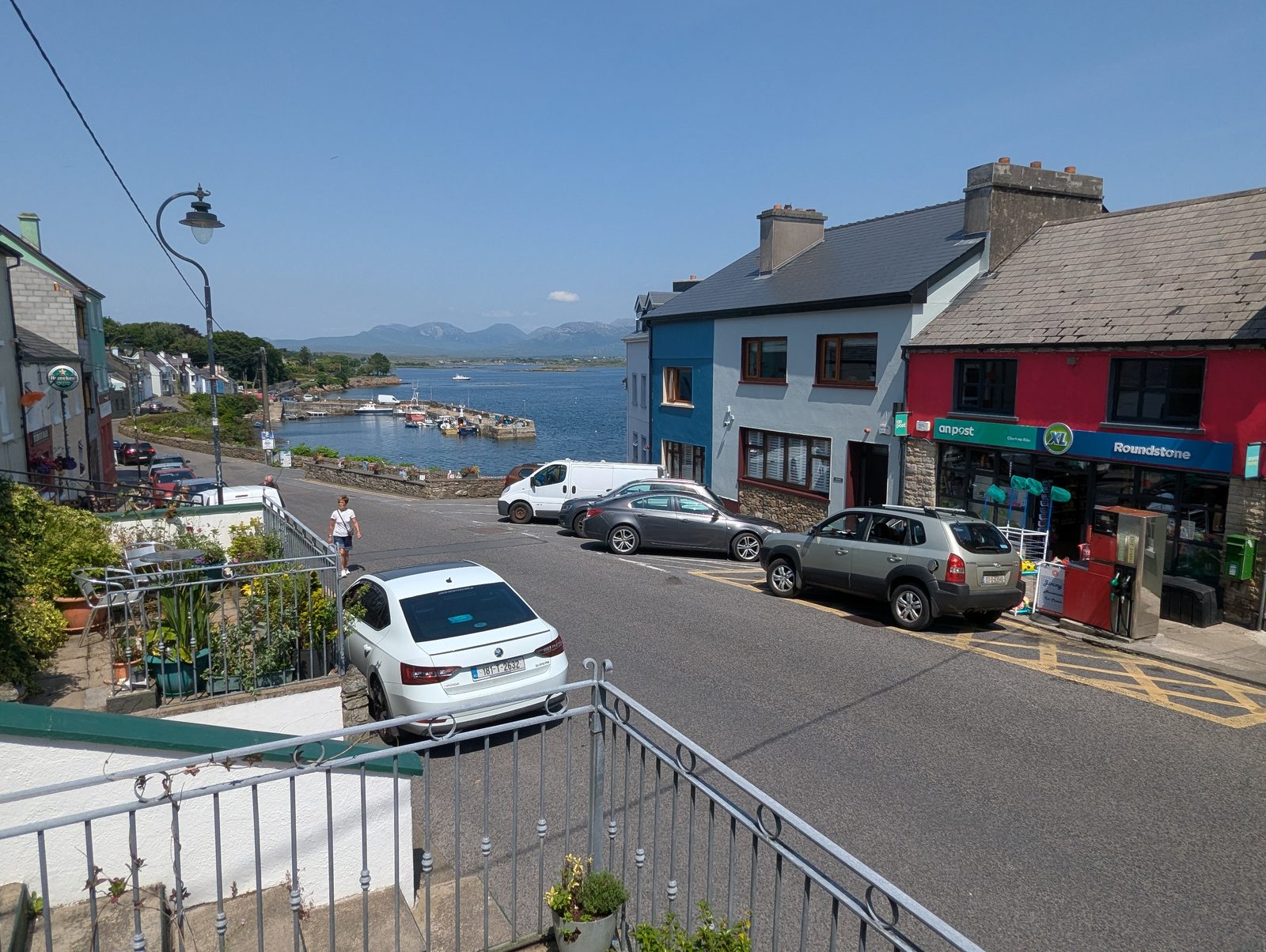 Roundstone harbour with fishing boats and the Twelve Bens in the distance